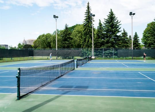 two people playing tennis on a tennis court
