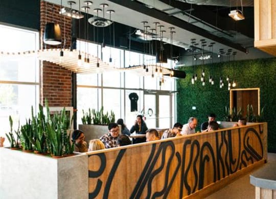 a group of people sitting at a table in a restaurant