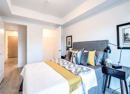 a bedroom with a bed and a night stand