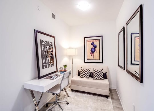 a white room with a desk and a couch