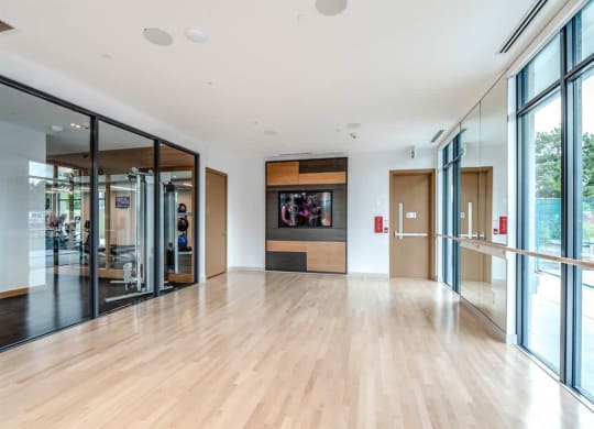 the living room has a large wood floor and glass doors