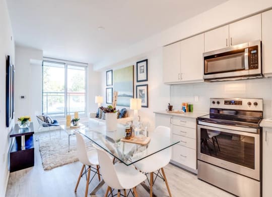a kitchen with stainless steel appliances and a glass table