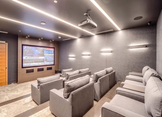 a large screening room with a projector screen on the wall
