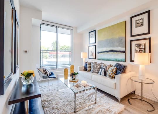 a living room with a couch and a glass table