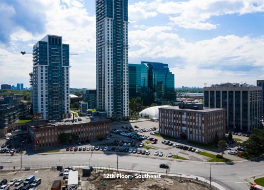 a city with tall buildings and a parking lot