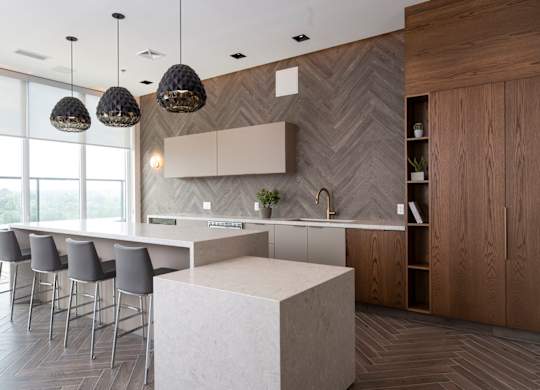 a large kitchen with a large white island and chairs