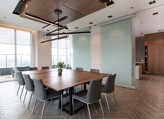 a conference room with a long wooden table and chairs