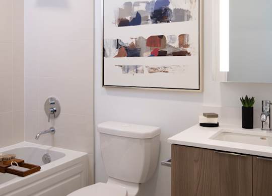 A white toilet sits next to a sink in a bathroom.