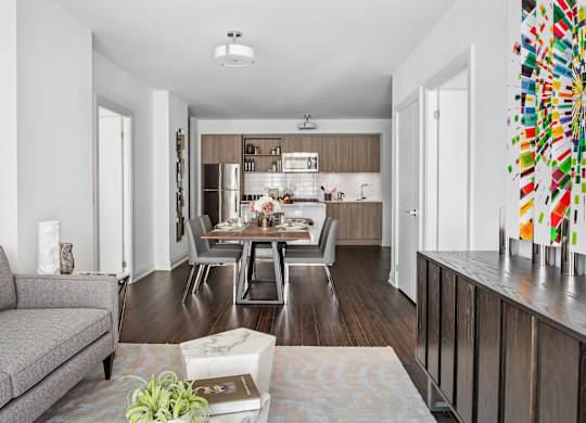 A modern kitchen with a dining table and chairs.