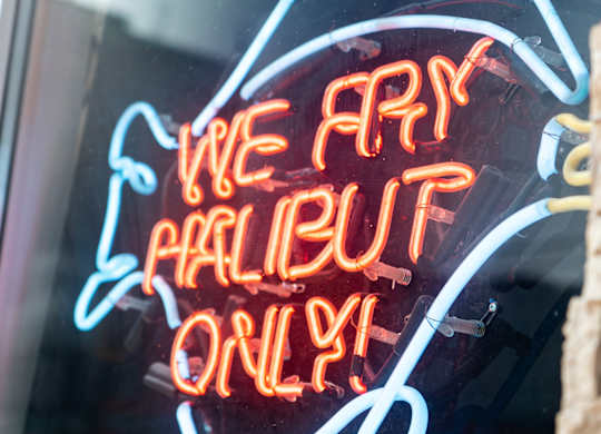 a neon sign in a window that reads we are halliburton only