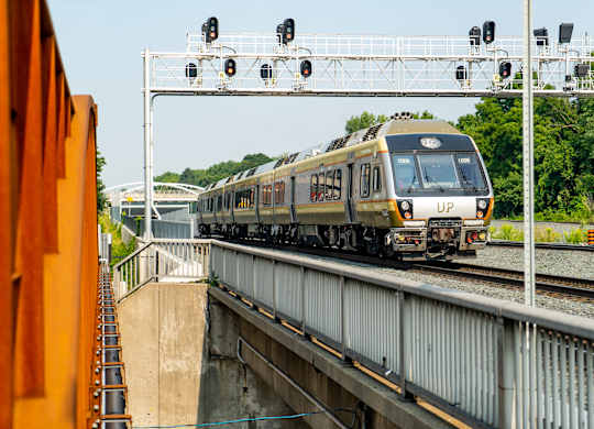 A train is passing through a railway station.
