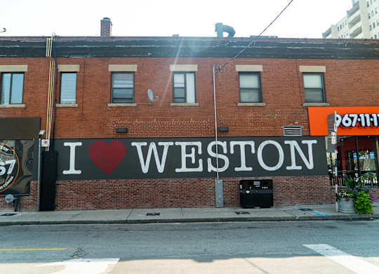 A brick building with a sign that says I love Weston.
