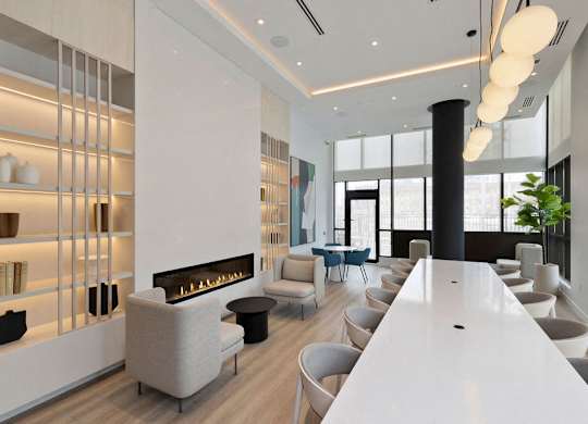 A modern living room with a fireplace and a long white table.