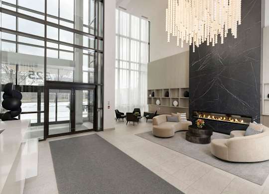A modern living room with a fireplace and a chandelier.
