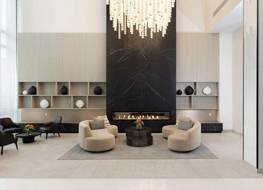 A modern living room with a fireplace and a chandelier.