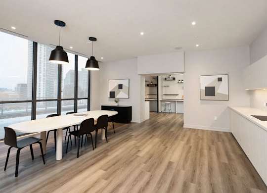 A modern kitchen with a dining table and chairs.
