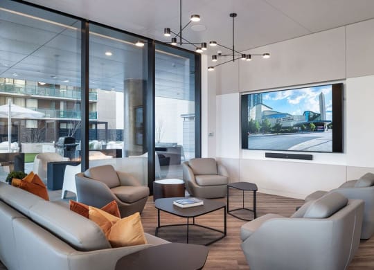 a living room with couches and chairs and a television