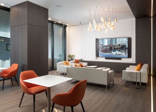 a living room with a tv and a table and chairs
