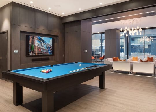 a pool table in a living room with a tv