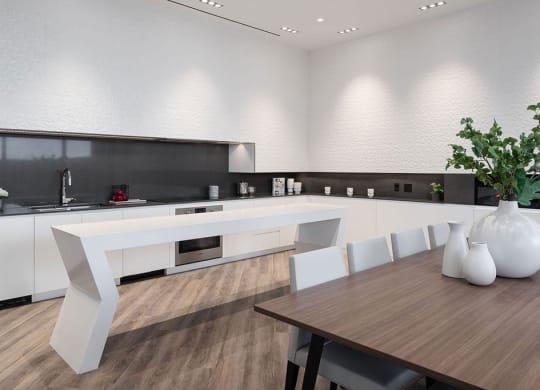 a large white kitchen with a table and chairs