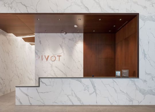the lobby of a hotel with a marble reception desk