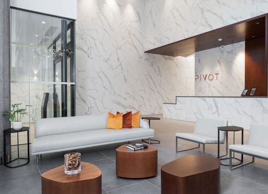 a lobby of a hotel with a couch and tables