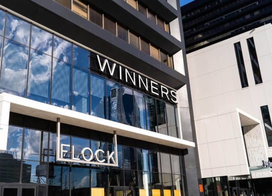the facade of a building with a wineries clock sign on it