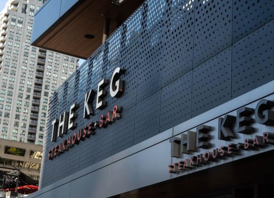a sign on the side of a building with skyscrapers