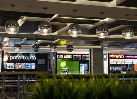 a restaurant in a mall with tables and chairs