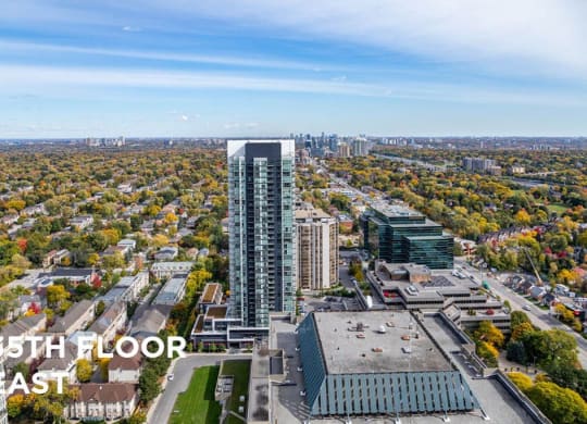 an aerial view of a city with a tall skyscraper
