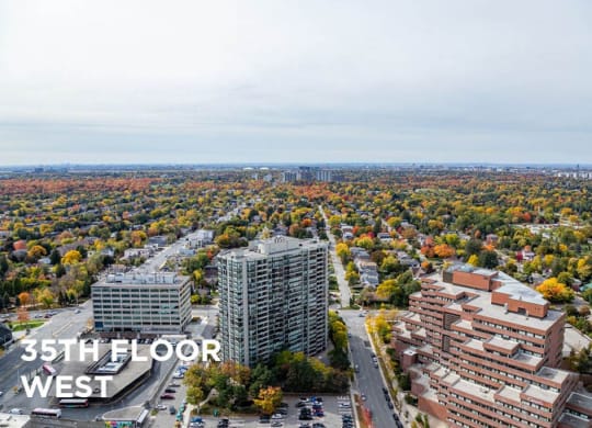 an aerial view of a city with tall buildings and trees