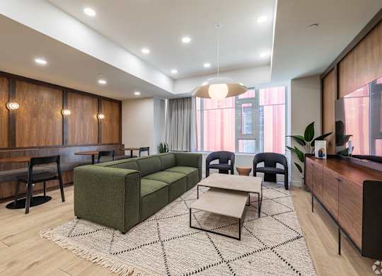 A modern living room with a green sofa and a coffee table.
