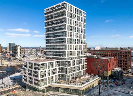 A large white building under construction in the middle of a city.