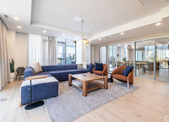 A modern living room with a blue sofa and wooden coffee table.