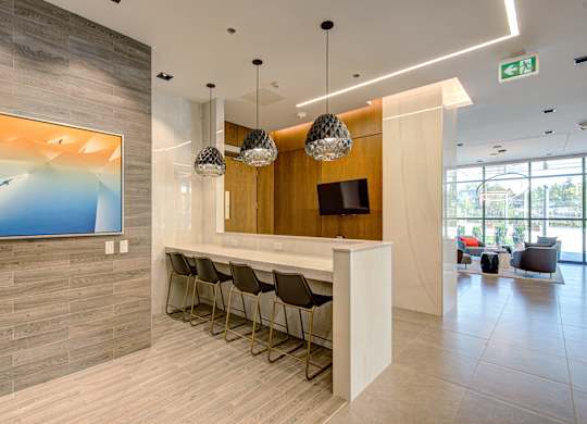 A reception area with a white counter and chairs.