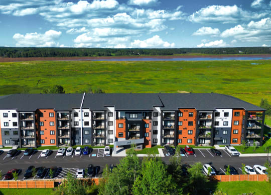 an aerial view of an apartment complex with a river in the background