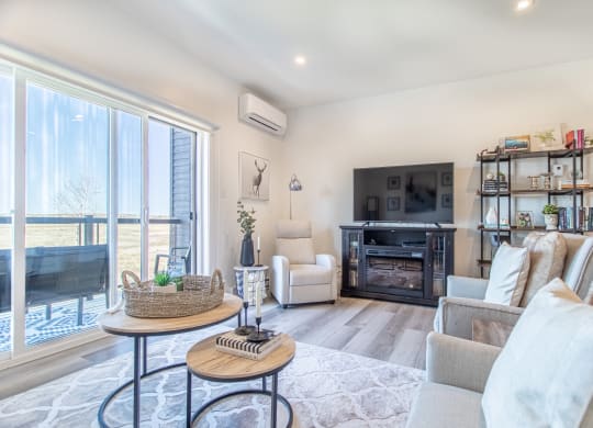 a living room with a couch and a chair and a television