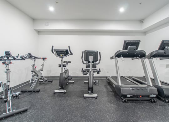 a gym with treadmills and other exercise equipment