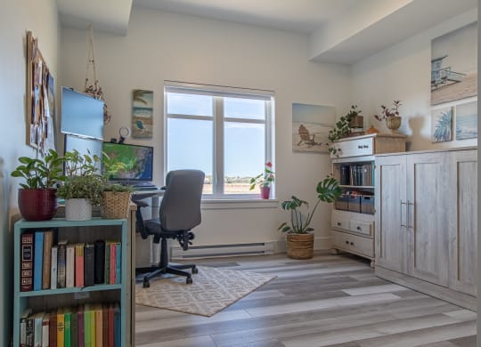 a home office with a desk and a window