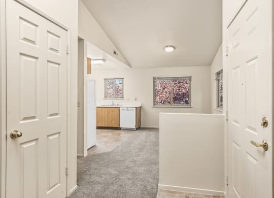 Hallway with white doors and a kitchen at Meadowview Apartments, Santa Rosa, CA