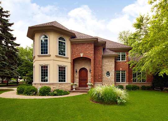 A house with a red brick facade and a brown roof.
