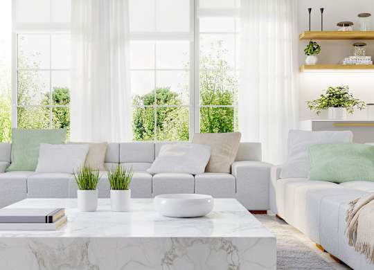 a white living room with couches and a coffee table