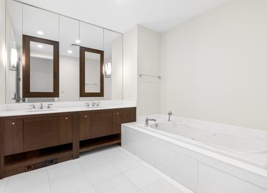 a large white bathroom with a tub and two sinks at HIGHGROVE, Connecticut