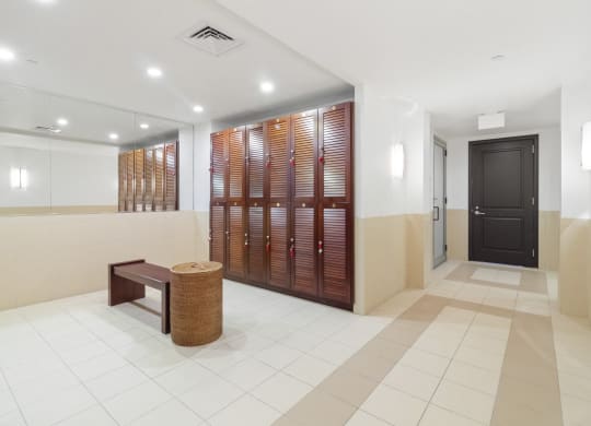 a lobby with a door to a locker room and a bench  at HIGHGROVE, Stamford, CT