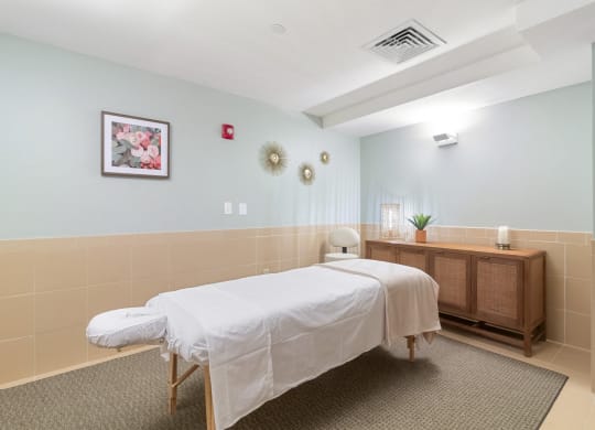 a treatment room with two beds and a wooden dresser  at HIGHGROVE, Stamford, CT, 06901