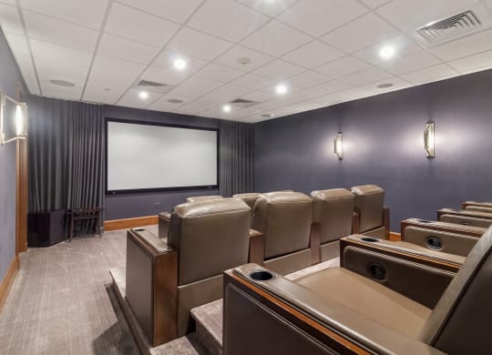 a conference room with leather chairs and a screen on the wall at HIGHGROVE, Stamford, 06901