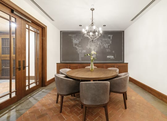 a dining room with a table and chairs and a chalkboard on the wall at HIGHGROVE, Stamford, CT, 06901