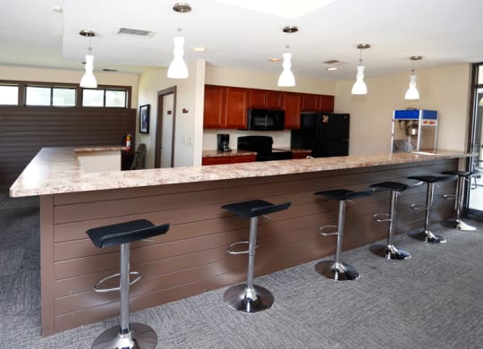 a kitchen with a counter top and stools
