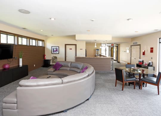 a living room with a large couch and a table with chairs