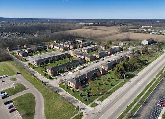 an aerial view of a neighborhood with houses and a highway
